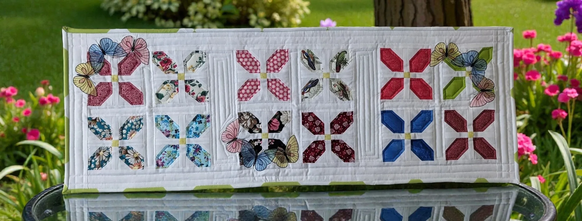 Table runner with butterfly and quilt block motif, colors red, blue, green, made of cotton